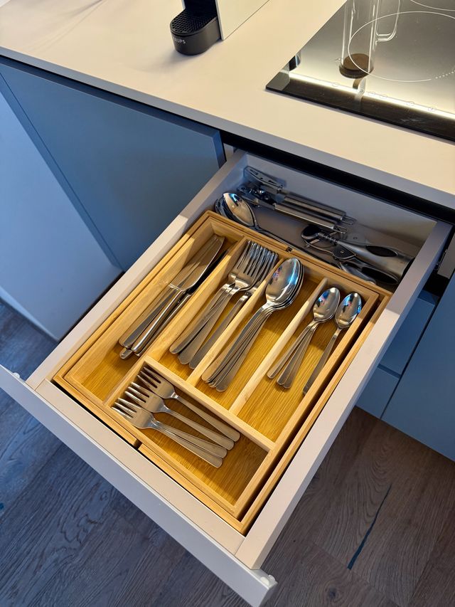 Besteck und Küchenhelfer in einer geöffneten Schublade der Loft-Küche